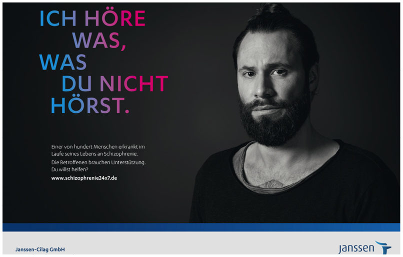 Schwarz Weiss Portrait von einem jungen Mann mit Vollbart. Aufmerksamkeitskampagne für Schizophrenie